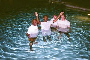 Timothy Snead (center) at his baptism with Anthony Eckels, Joseph Kaile and Corey Jones